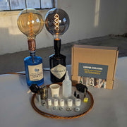 Bottle lamp making set with Hendrick's and Gunpowder gin bottles, light bulbs, and tools