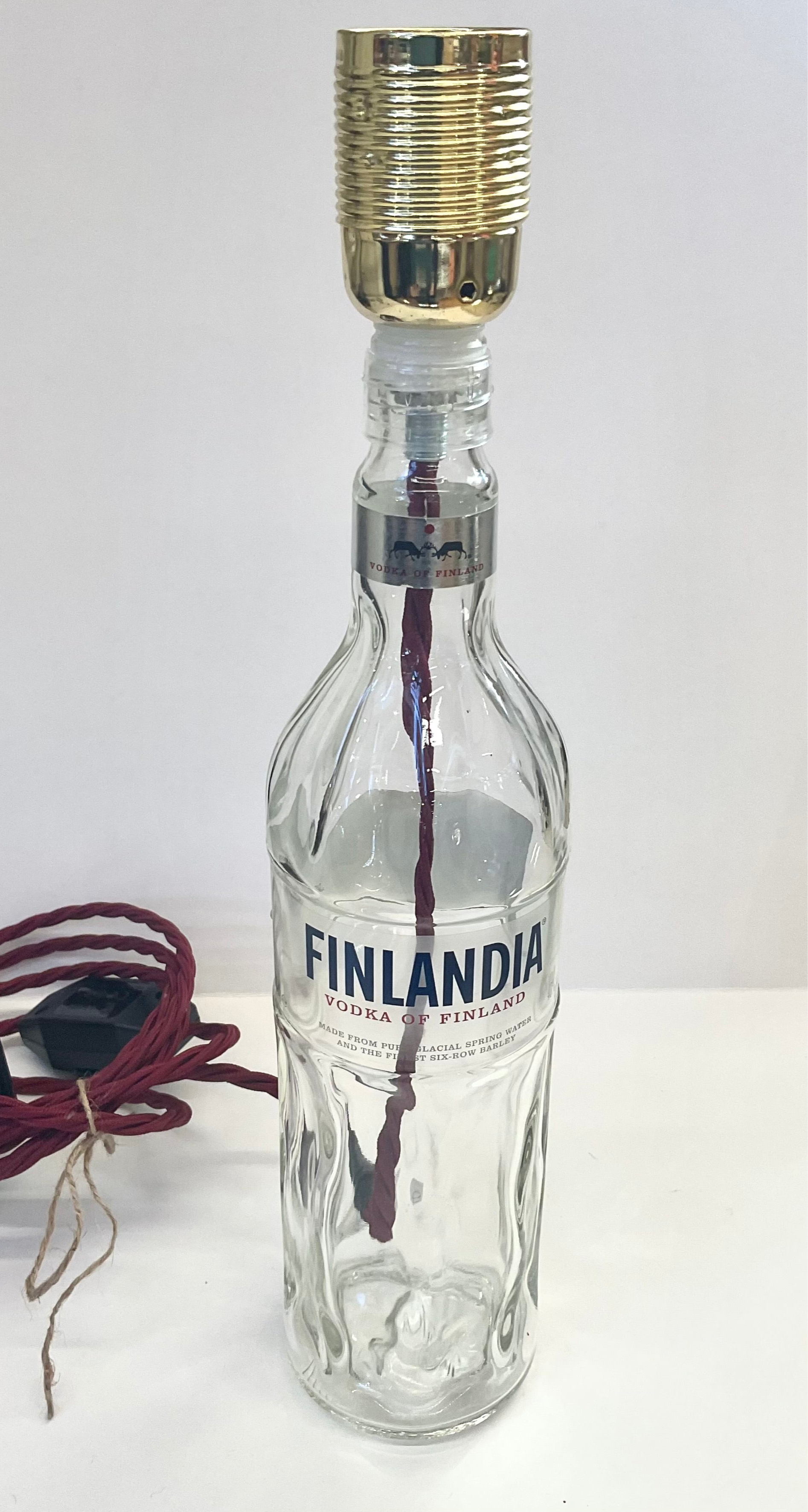 Finlandia vodka bottle upcycled into a unique lamp on a white background