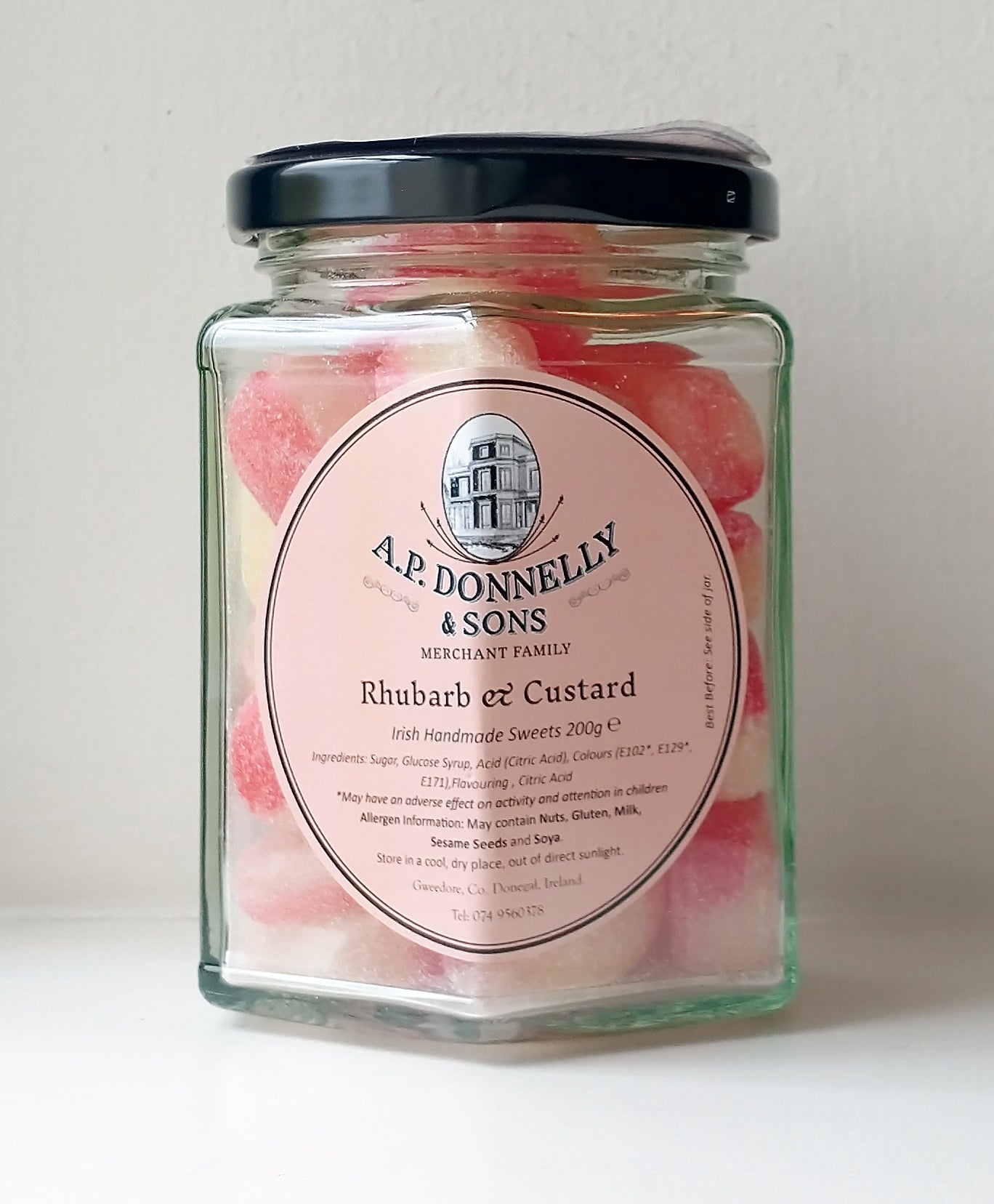 Jar of A.P. Donnelly & Sons Rhubarb & Custard sweets on a light background
