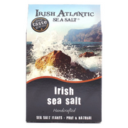 Packaging of Irish Atlantic Sea Salt Flakes with a background image of waves crashing against rocks.
