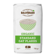 A 750 g white bag of Ballybrado Organic Standard Oat Flakes, featuring a green and brown logo and a bowl illustration on the front.