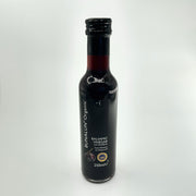 A bottle of Bunalun Organic Balsamic Vinegar of Modena, 250ml size, with labels indicating its organic certification and origin.