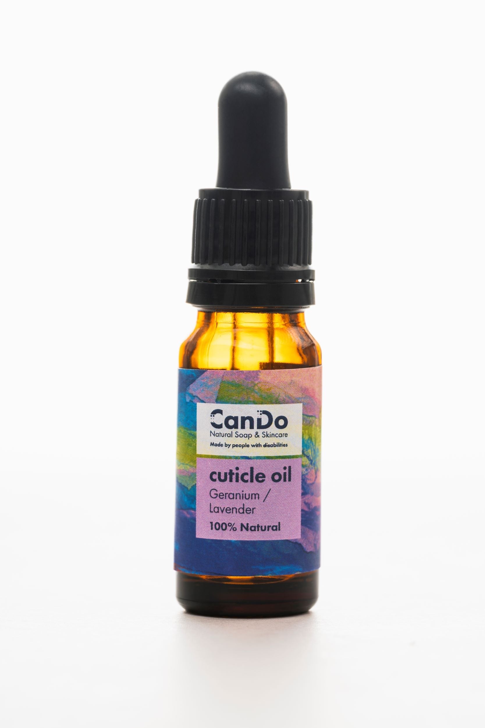 Bottle of CanDo cuticle oil with a dropper on a white background