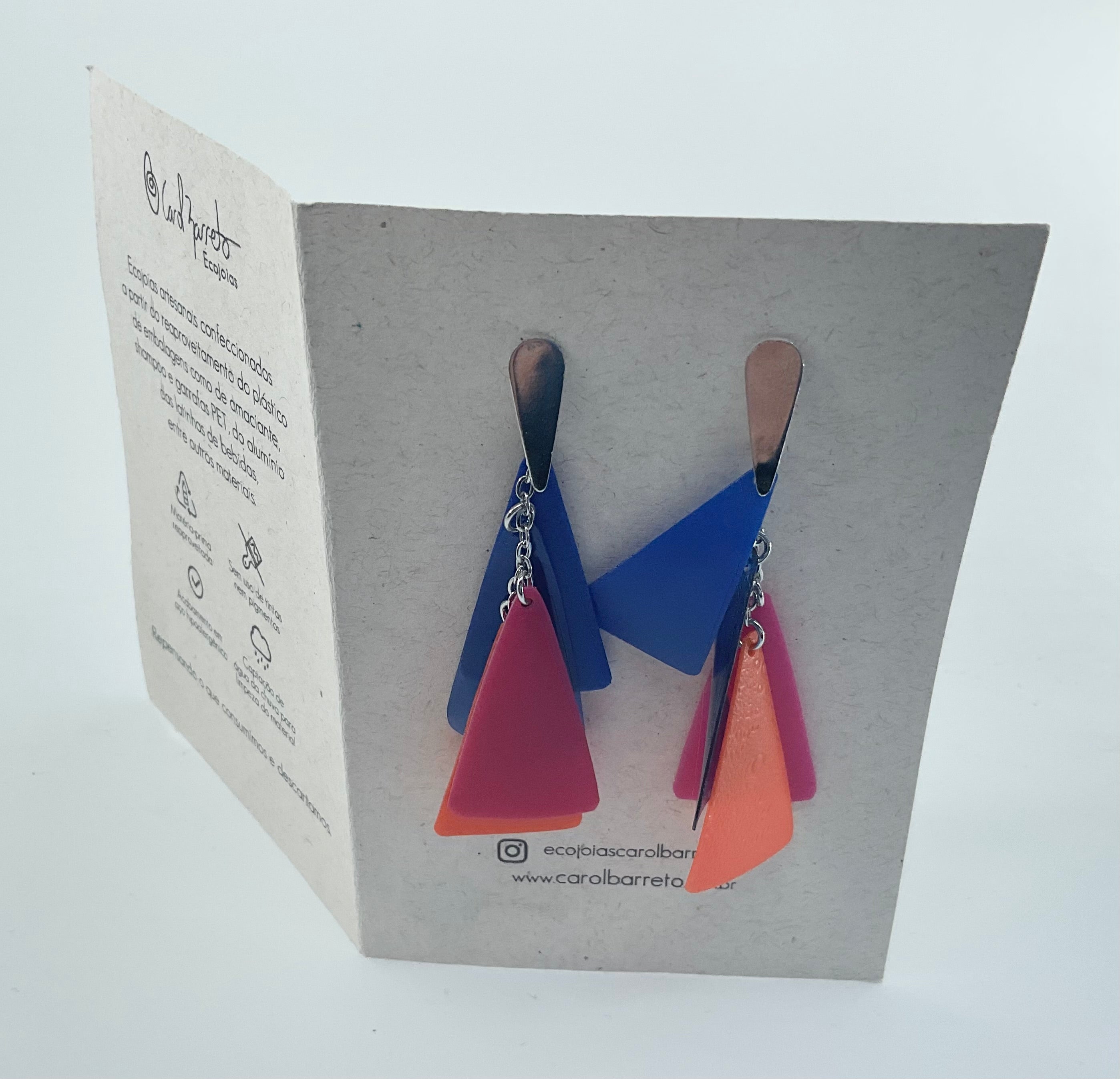 Colorful geometric earrings on a branded card with text
