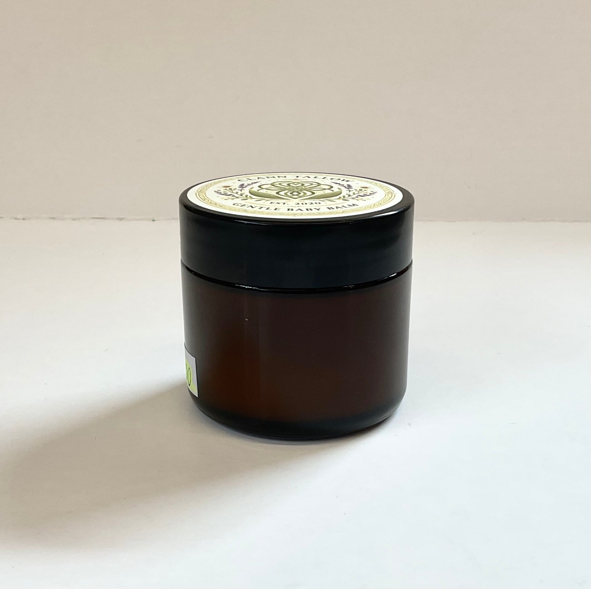 Black jar with a white lid on a light background Clann Tallow