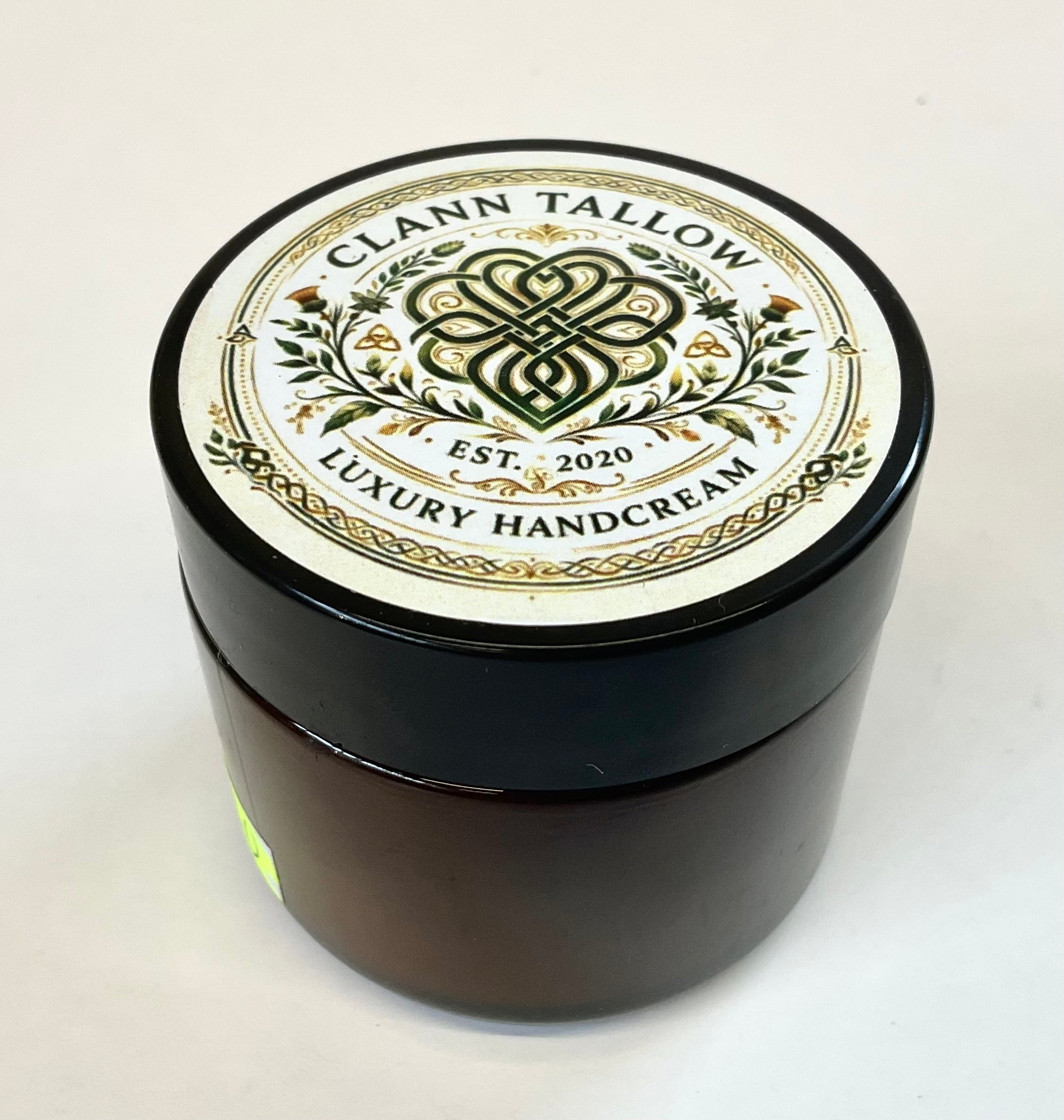 Black jar of Clann Tallow Luxury Handcream on a white background