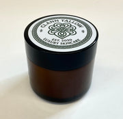 Brownglass  jar with black lid featuring 'Clann Tallow Luxury Skincare' on a white background