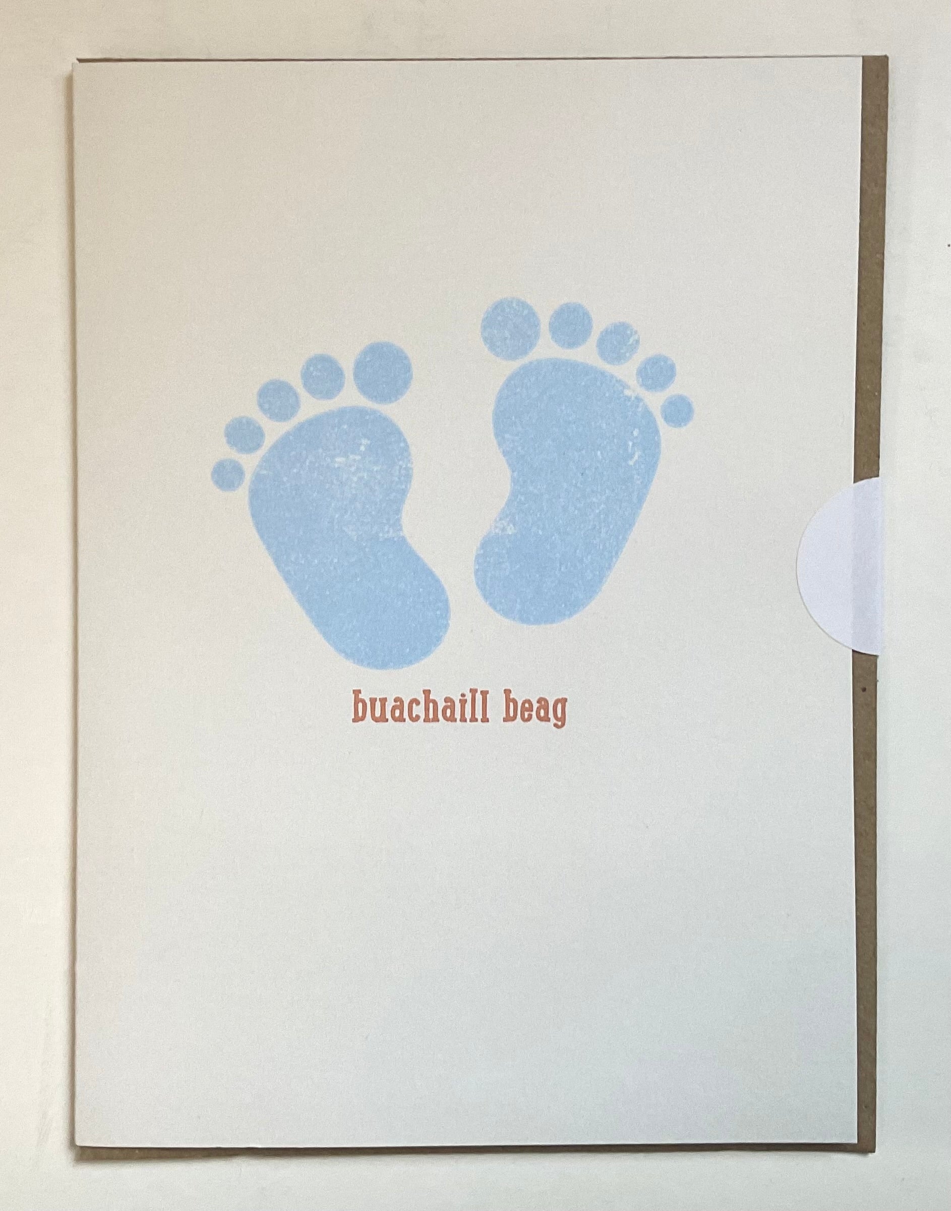Framed artwork with blue footprints and text on a light background