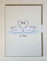 Card with two swans forming a heart on a light background, featuring the brand 'Le Chéète'.