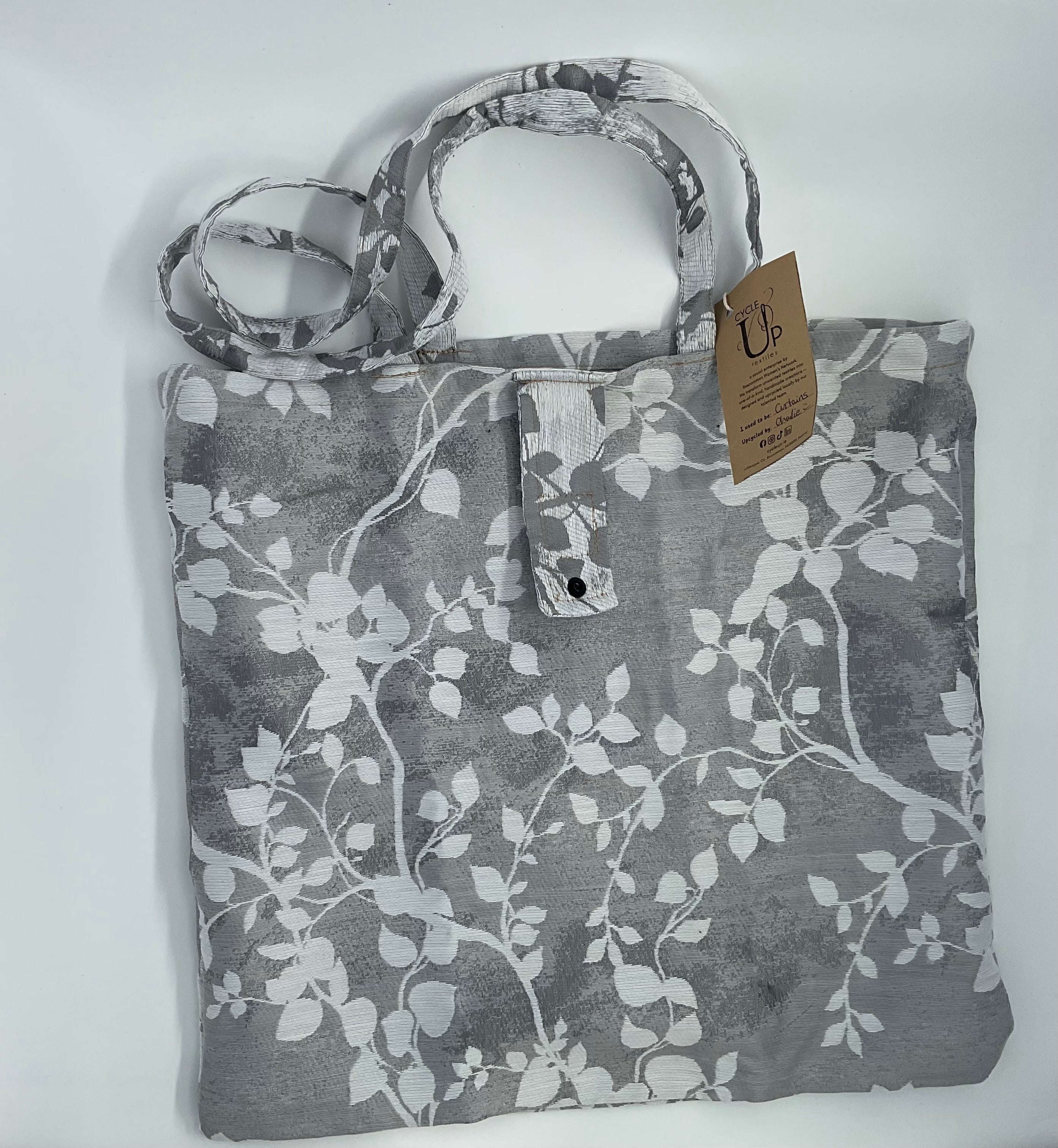 a grey floral tote bag