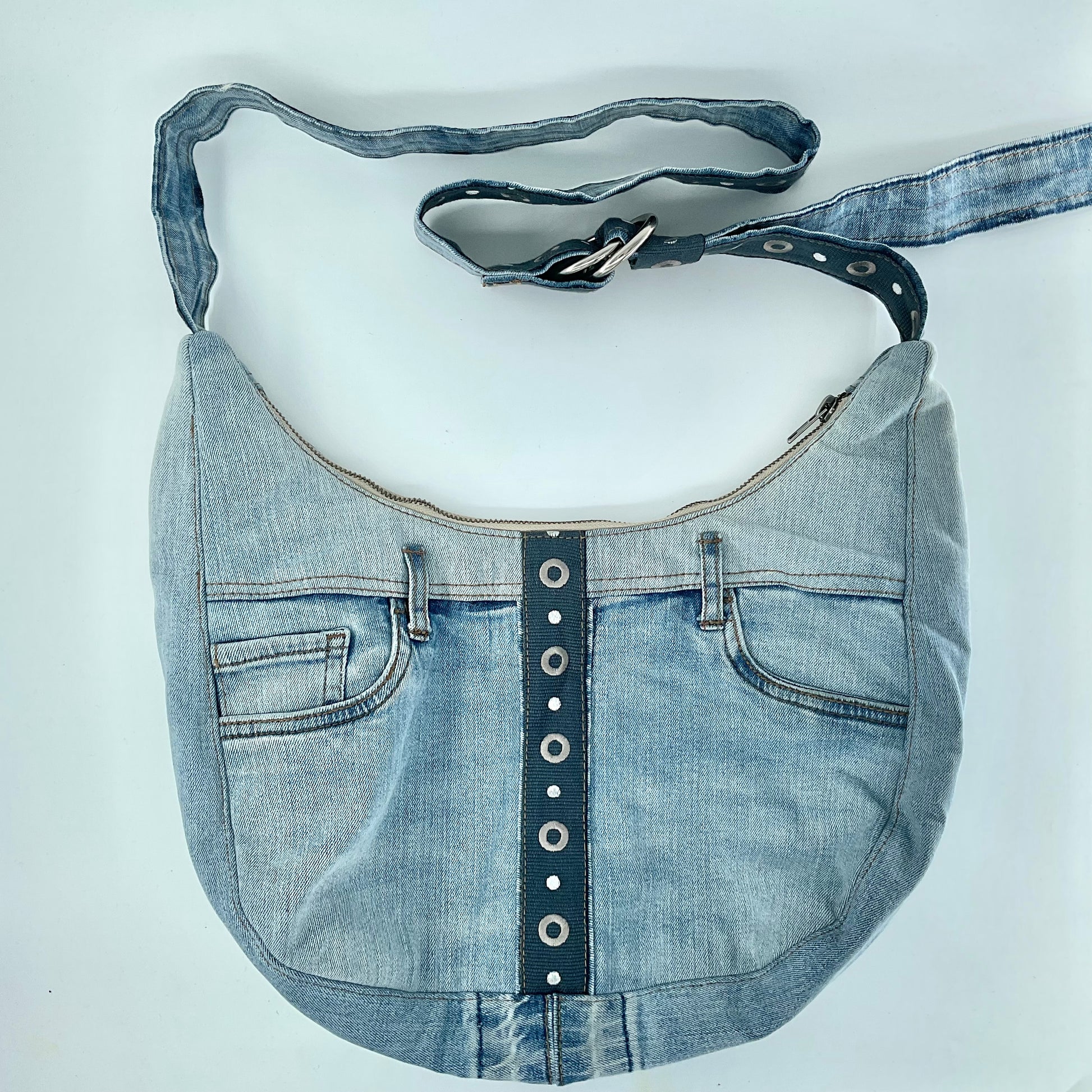 Denim handbag with a strap on a white background