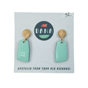 Light green drop earrings with gold loop and disc stud on white card background