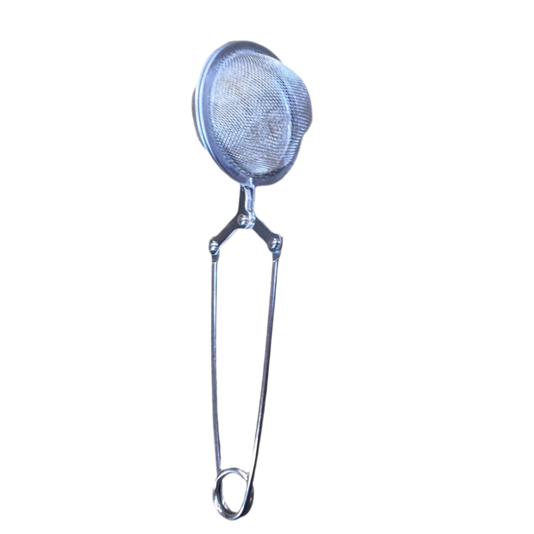 Metallic tea strainer on a white background
