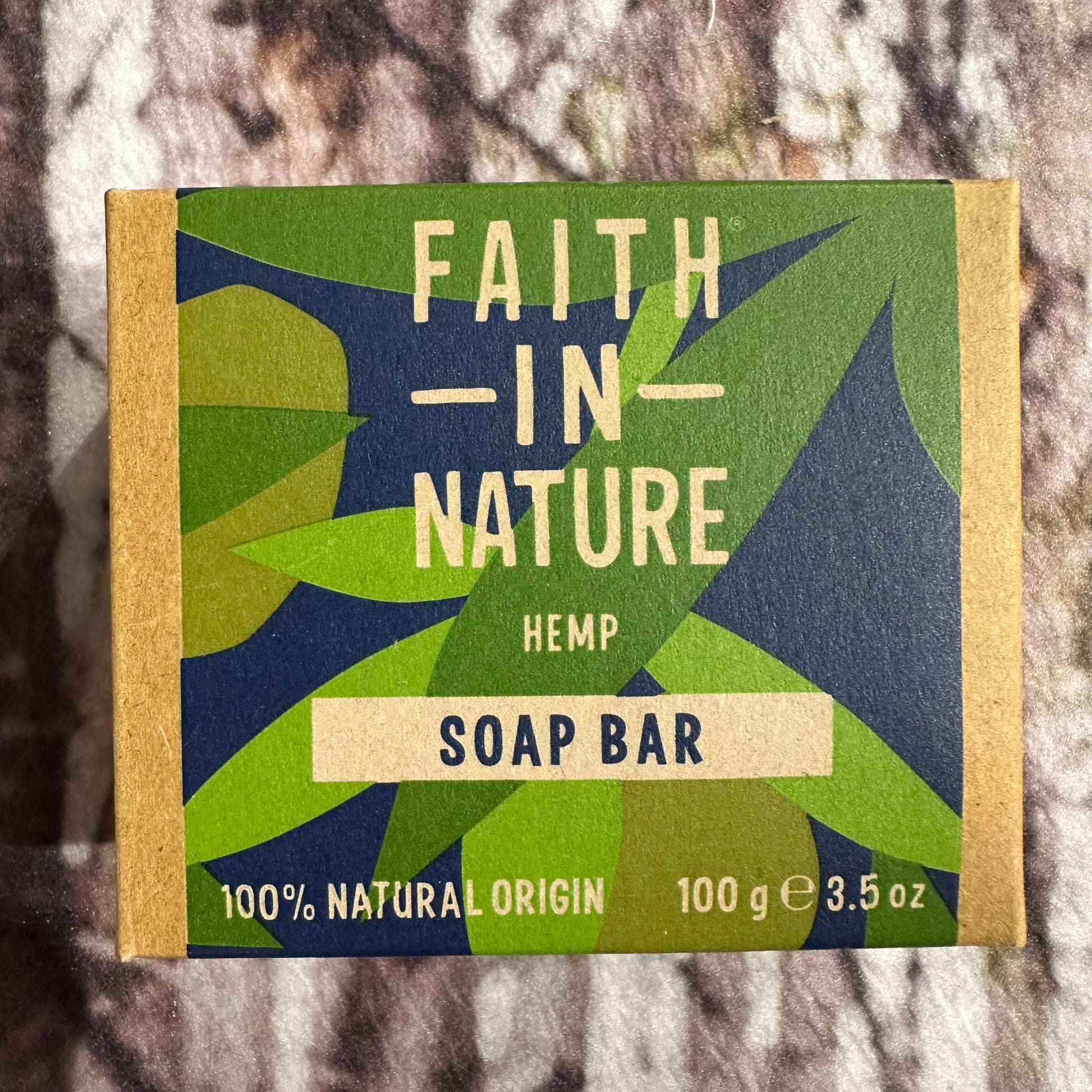 Soap bar packaging with 'Faith in Nature' branding on a textured background