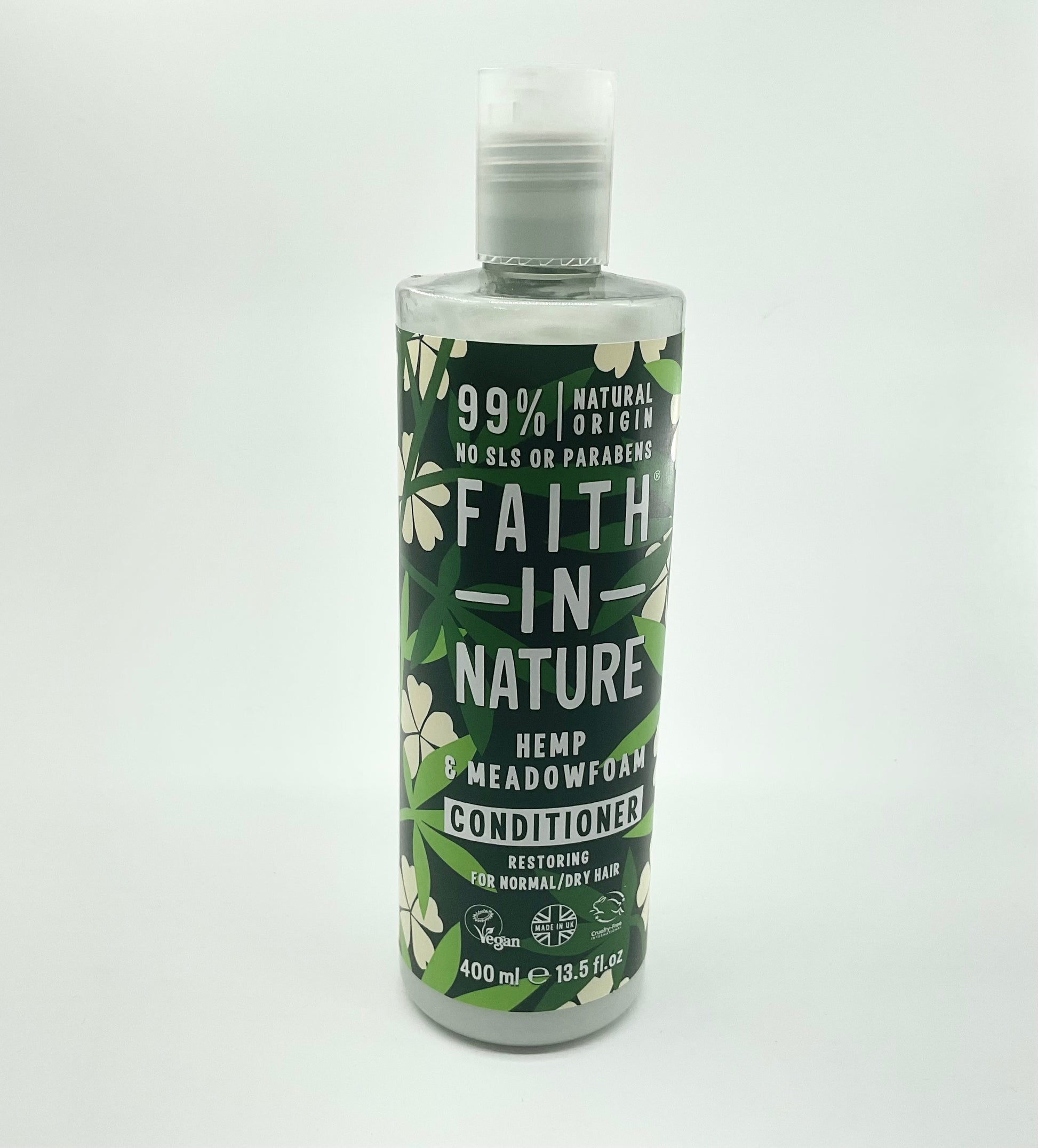 A bottle of FAITH IN NATURE Hemp & Meadowfoam Conditioner, 400 ml. Packaging is predominantly green with floral patterns and product information text.