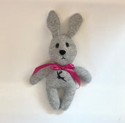 Grey stuffed bunny with a pink bow and a with a reindeer design on its chest