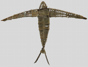 A willow swallow sculpture with an open wingspan, made from organically grown willow, soaked in water and hand-sorted for color, shape, and size.