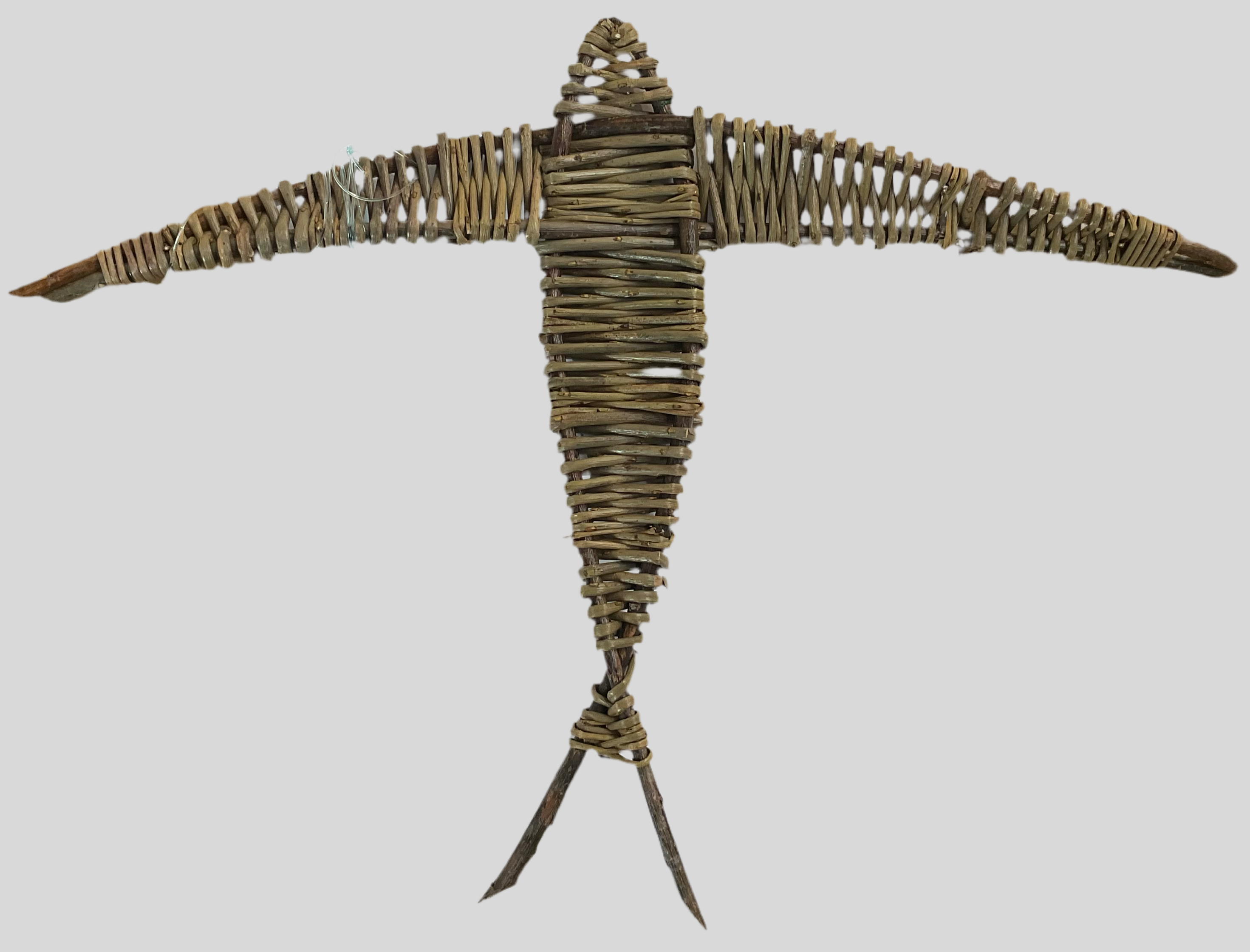 A willow swallow sculpture with an open wingspan, made from organically grown willow, soaked in water and hand-sorted for color, shape, and size.