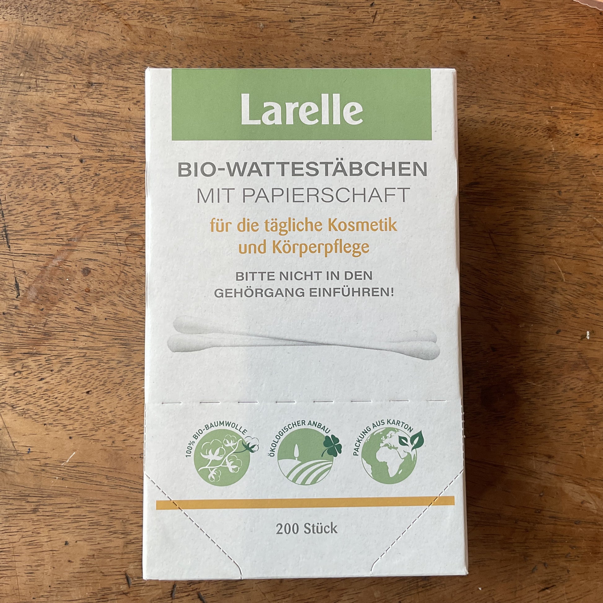 green and white paper box of cotton buds