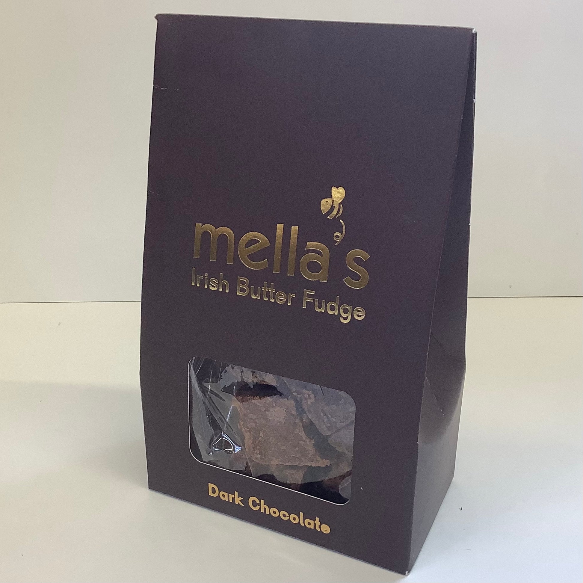 A dark chocolate bag of Mella's Irish Butter Fudge, featuring a deep purple packaging with gold lettering and a clear window showing the dark chocolate pieces inside.