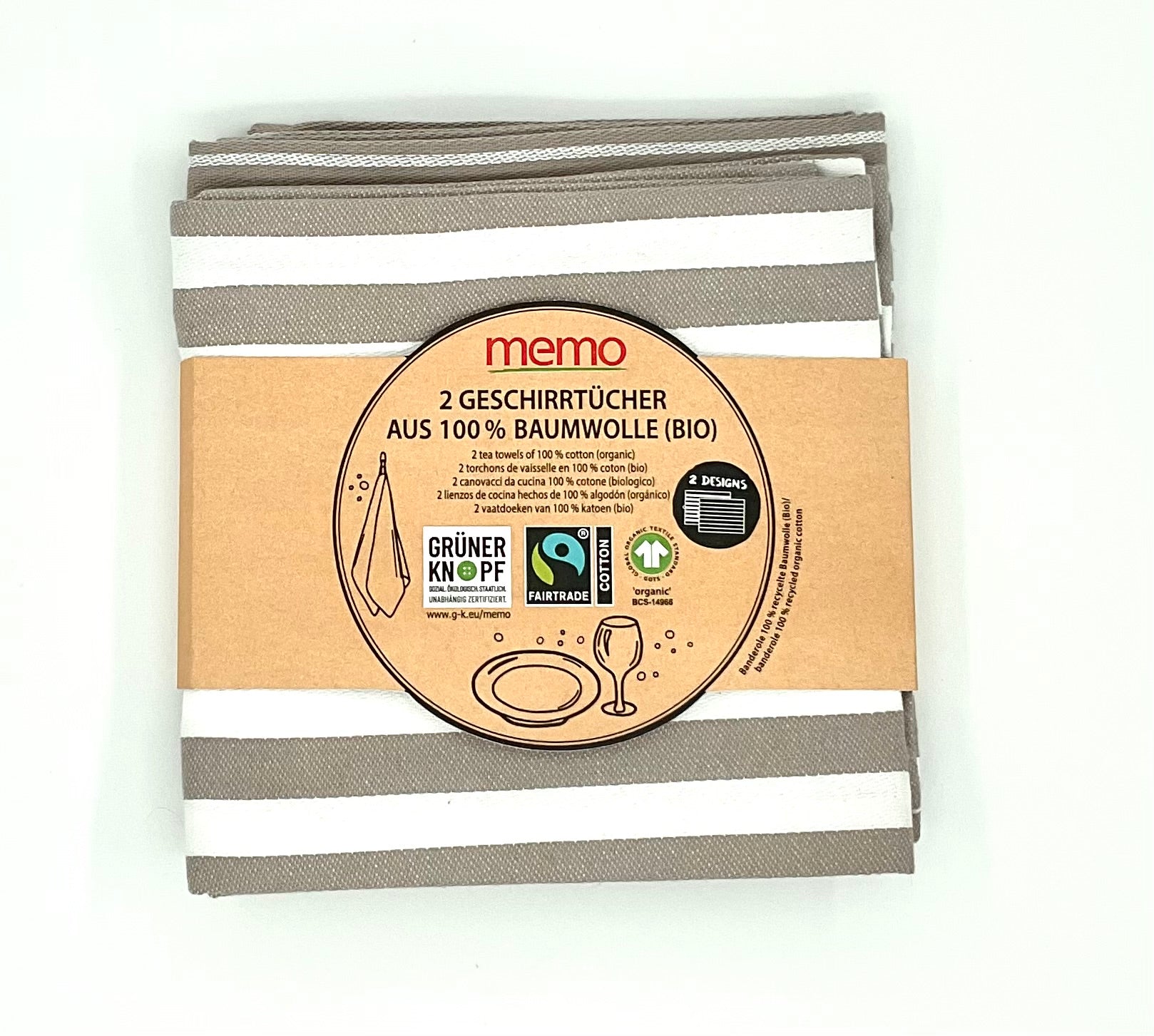 Pack of 2 striped Memo brand tea towels in beige and white, with packaging indicating they are made from 100% organic cotton and are Fair Trade certified.