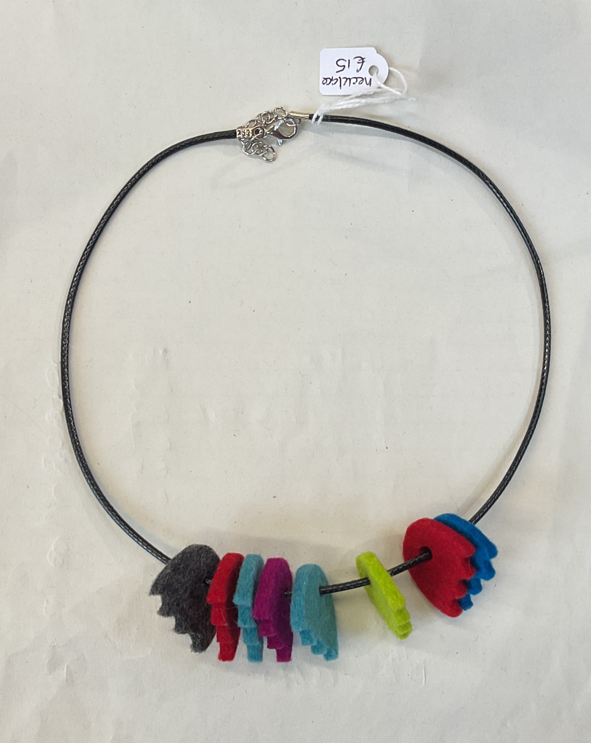 Necklace with colorful felted beads on a white background