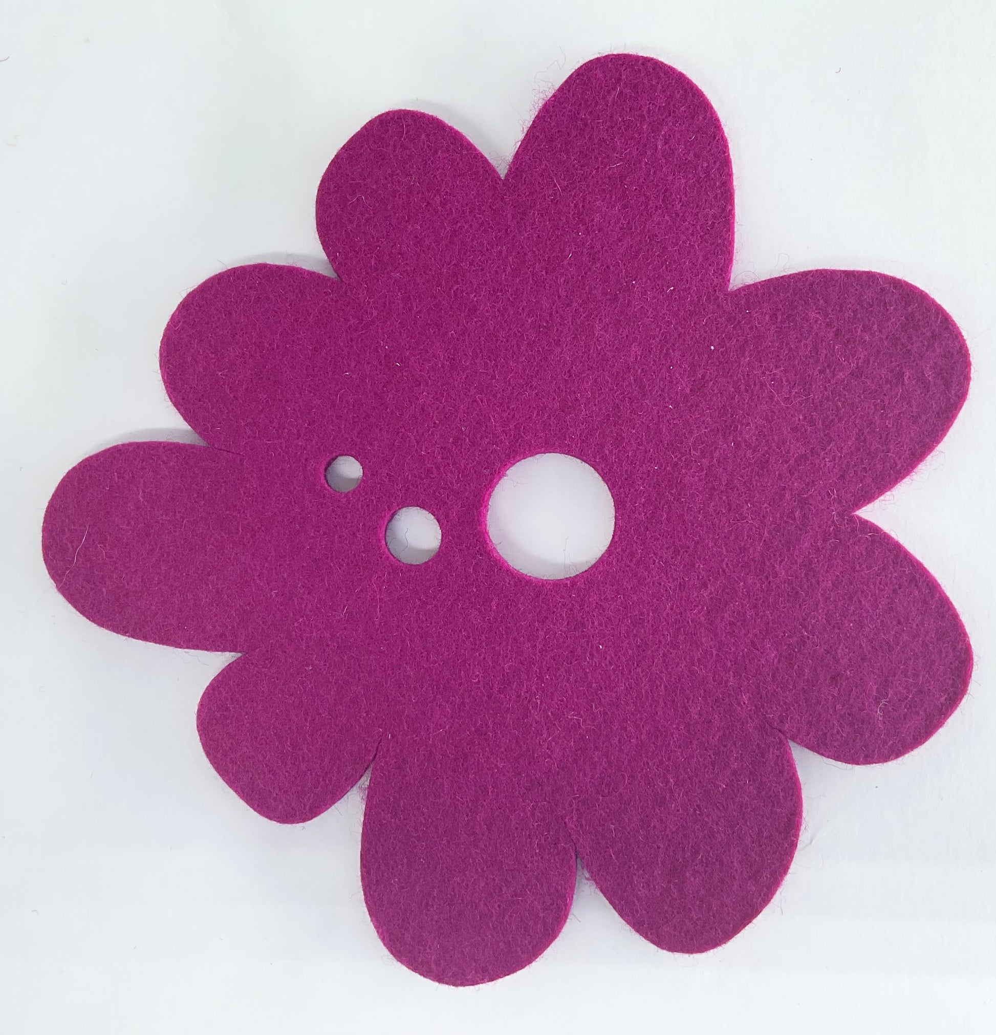 Purple flower-shaped pot stand on a white background