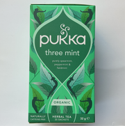 A box of Pukka Three Mint herbal tea with illustrations of mint leaves and the text highlighting pure spearmint, peppermint, and field mint.