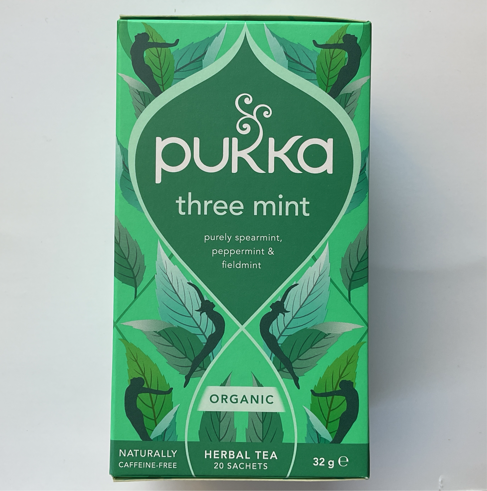 A box of Pukka Three Mint herbal tea with illustrations of mint leaves and the text highlighting pure spearmint, peppermint, and field mint.
