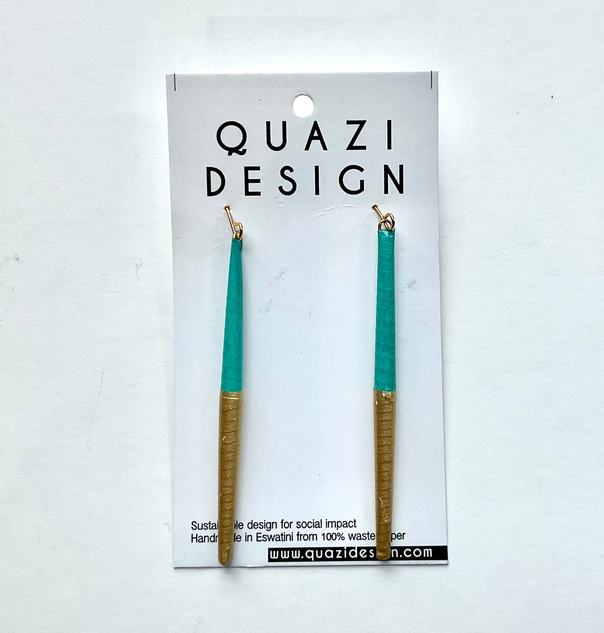 Teal and gold earrings on a Quazi Design card against a white background