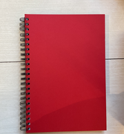 A red hardcover notebook with a wire binding, A4 size, lying flat on a surface.
