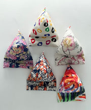 Five colorful fabric triangles on a white background