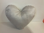 Heart-shaped pillow with a textured surface on a white background