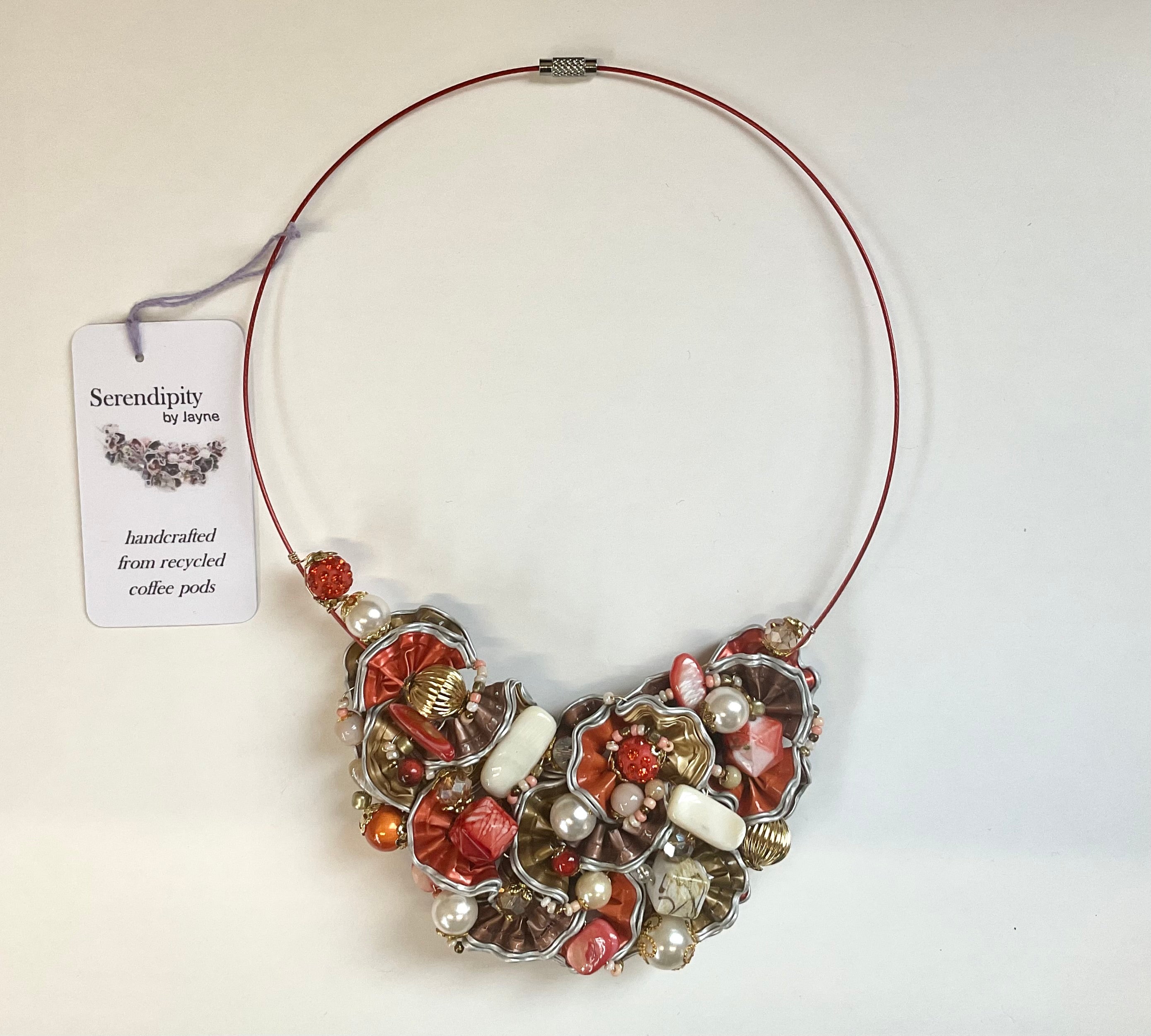 Decorative necklace with a 'Serendipity by Jayne' tag on a white background