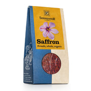 A package of Sonnento Saffron threads, whole and organic, in a blue and beige paper bag with a yellow label and a purple flower graphic, featuring a circular window showing the red saffron threads inside.