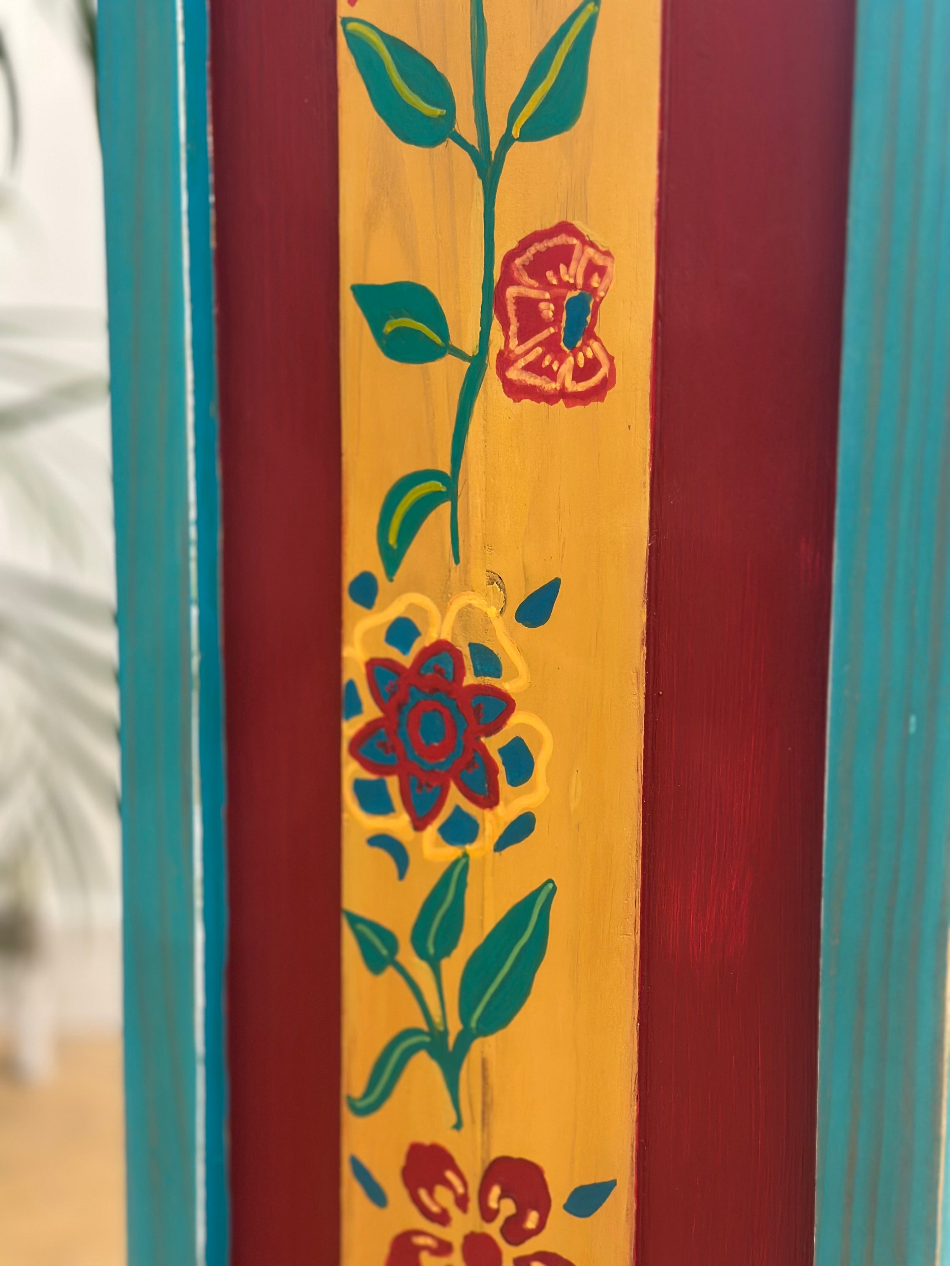 Decorative panel with floral designs on a wooden surface