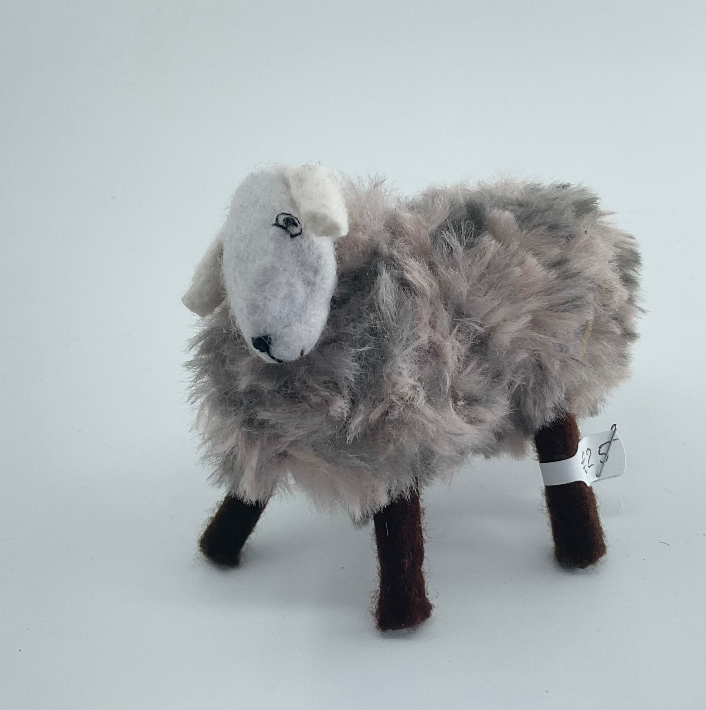 Felted toy sheep on a white background