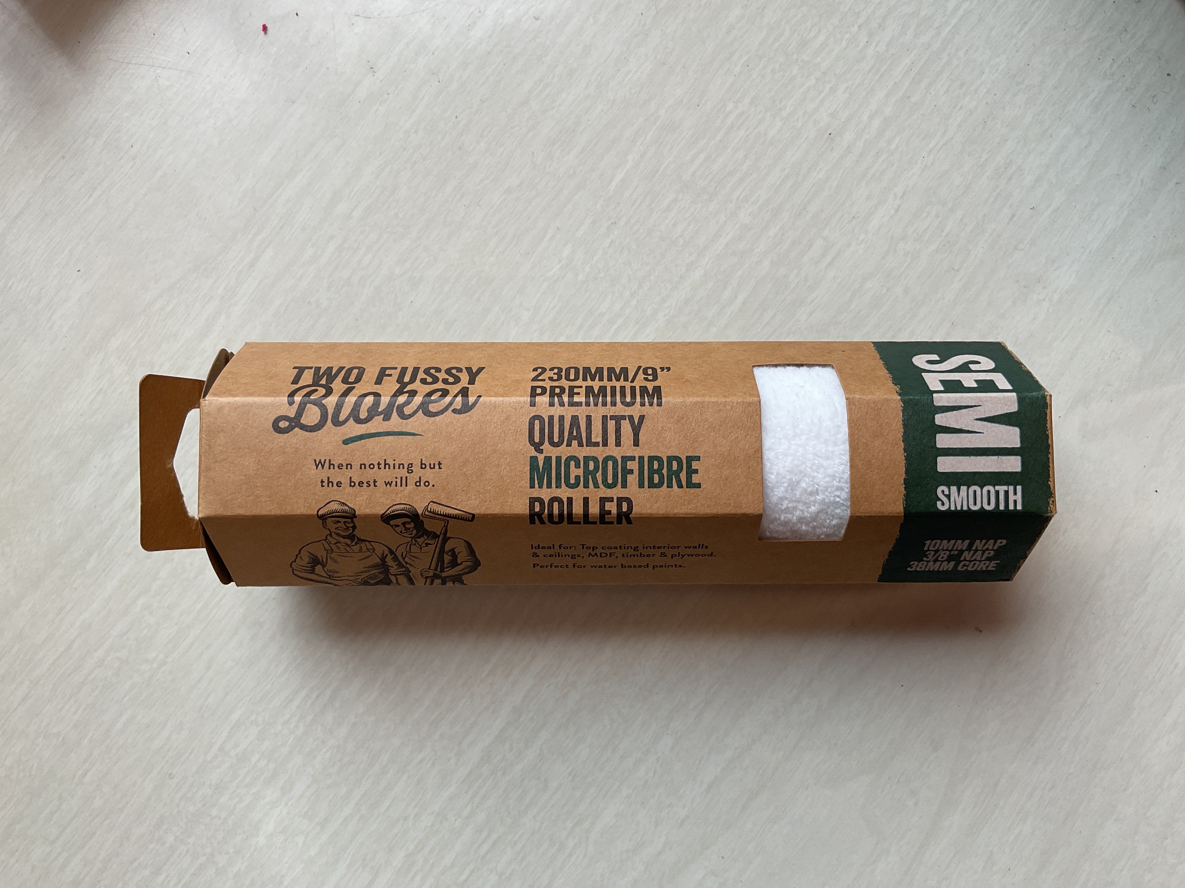 Packaged microfiber roller head with branding visible on the packaging.