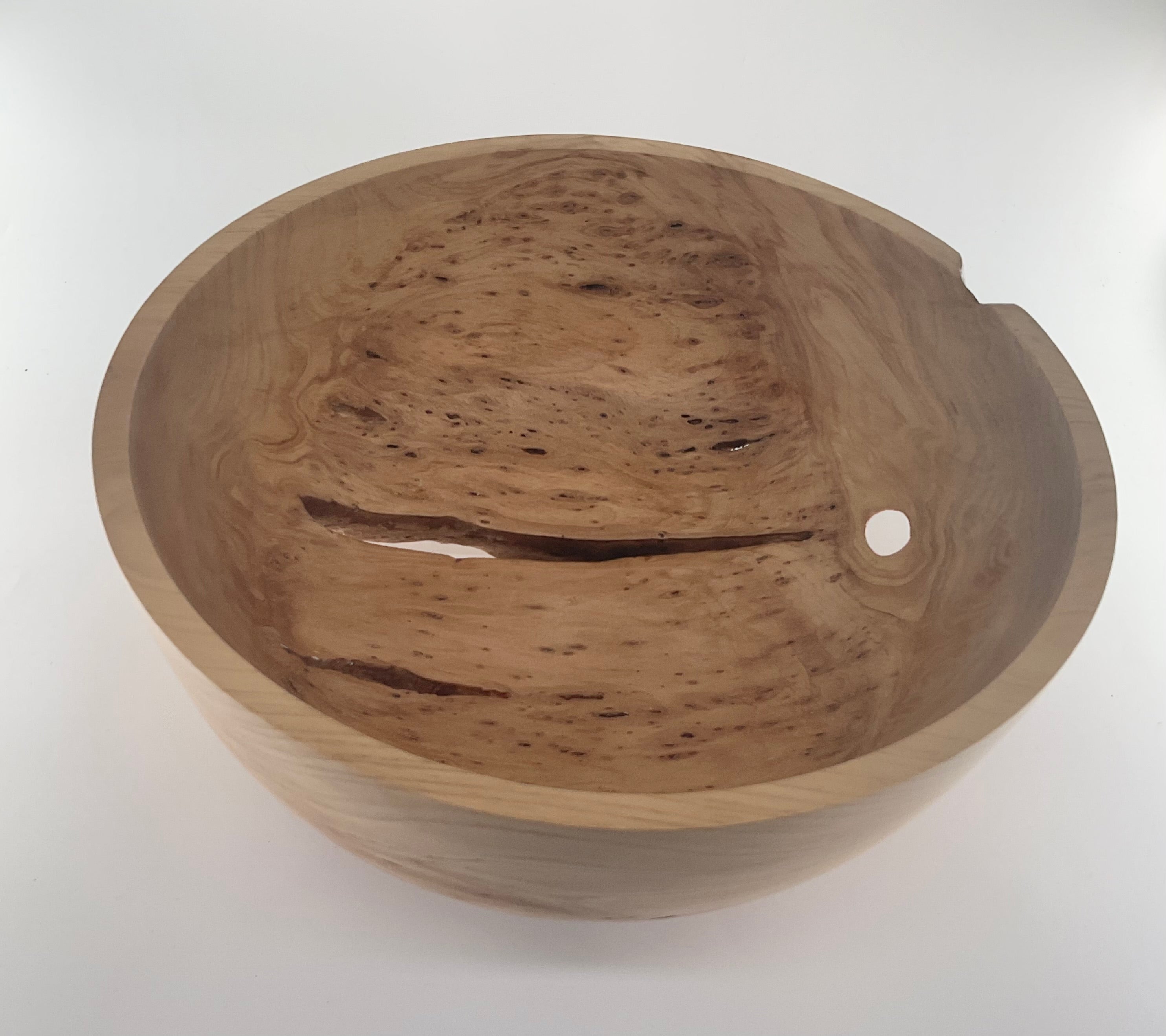 Wooden bowl with a smooth finish on a white background