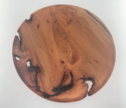 Round wooden plate  with natural grain and blemishes on a white background