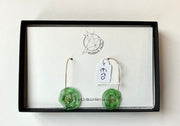 Green earrings on a card with 'Wildbird Studio' branding on a white background