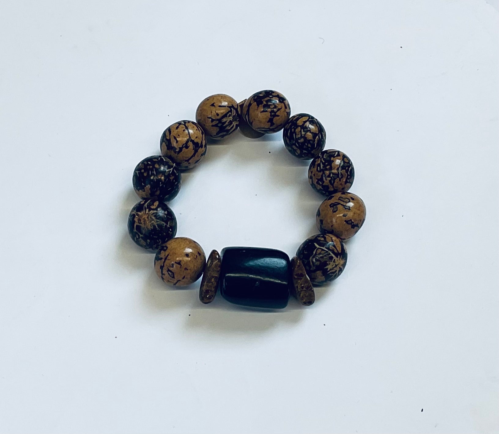 Beaded bracelet with a mix of round and rectangular beads on a white background