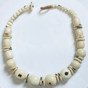 Necklace with large cream-colored beads on a white background