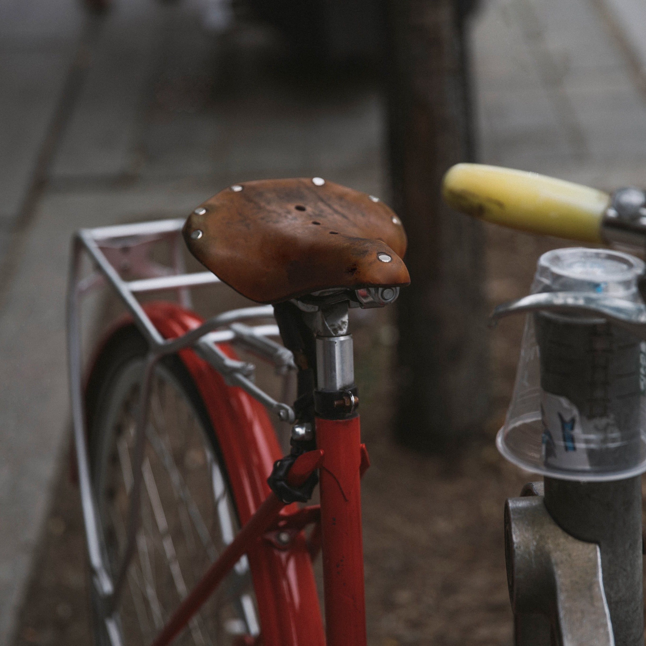 Closeup of a saddle on a bike in a workshop.