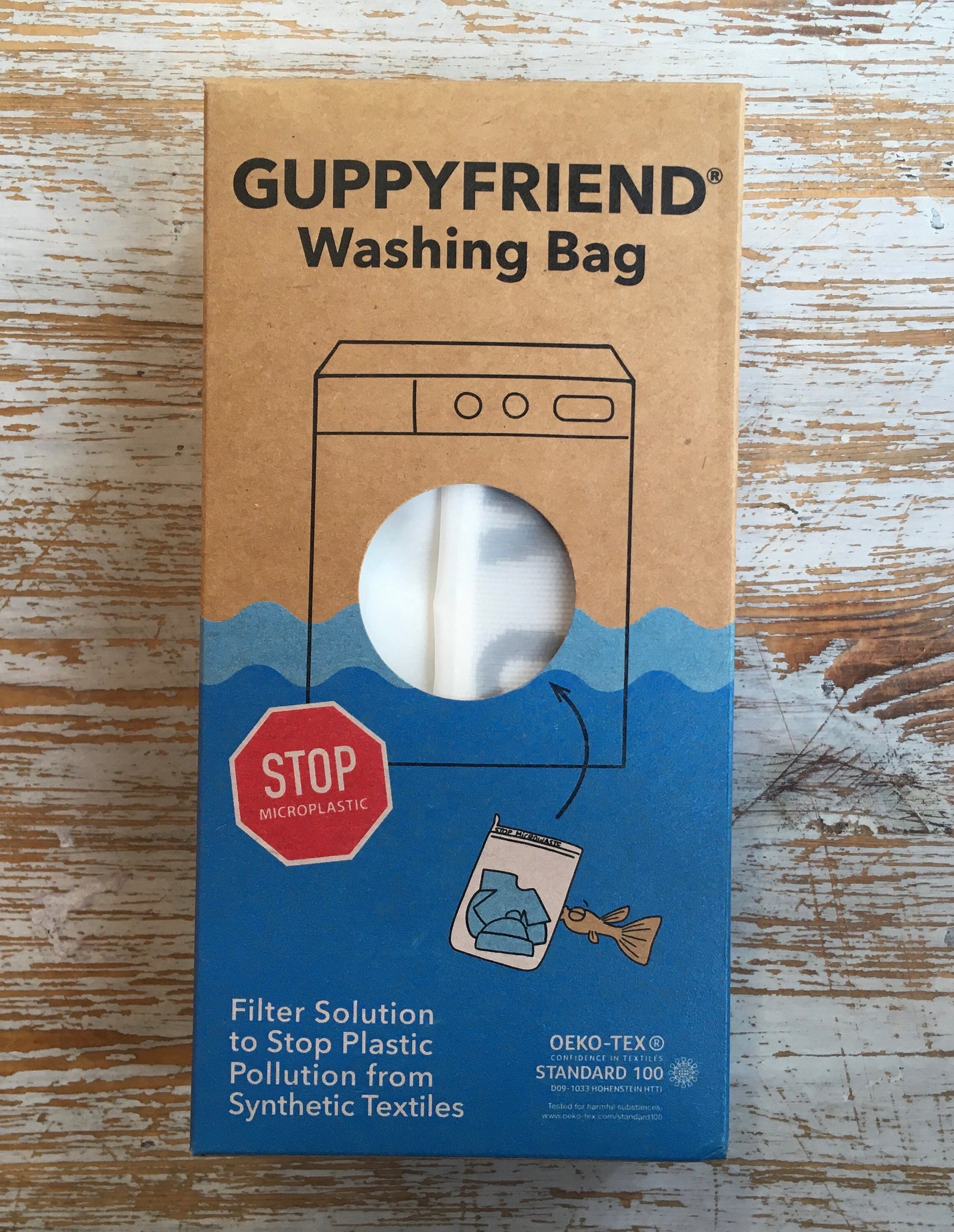 Packaging of Guppyfriend Washing Bag with visual representation of the product and text emphasizing its purpose to reduce plastic pollution from synthetic textiles.