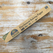 A pack of If You Care Parchment Baking Paper lying on a wooden surface.
