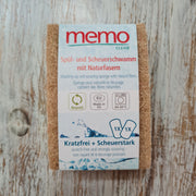 A Memo brand cleaning sponge in natural color, packaged in a cardboard box with blue and white design, highlighting its natural fibers and suitability for dishwashing and scouring.