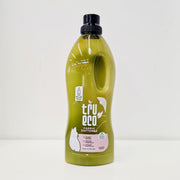 A bottle of TruEco fabric softener with a green label, indicating that it is eco-friendly and made from plant-based ingredients.