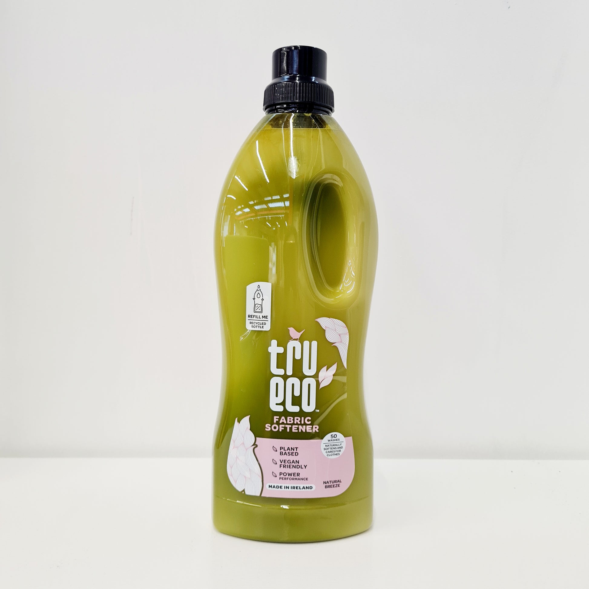 A bottle of TruEco fabric softener with a green label, indicating that it is eco-friendly and made from plant-based ingredients.